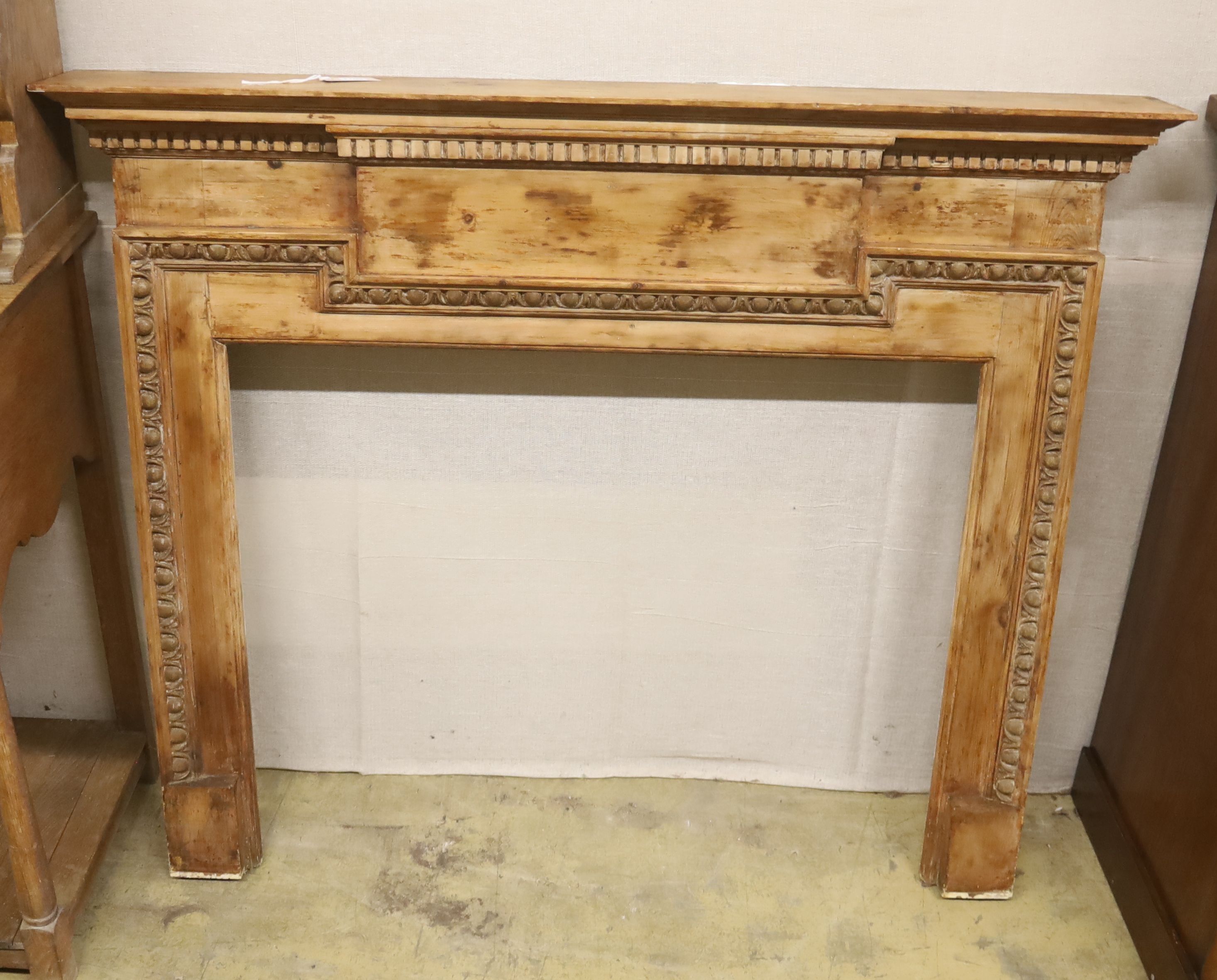 An early 20th century pine fire surround, length 135cm, height 111cm